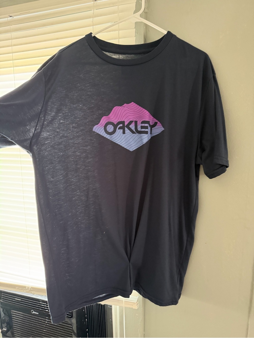 Oakley Men’s Black Tee with Pink-to-Blue Gradient Logo